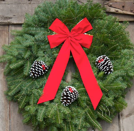 Green wreath with red ribbon and pinecones