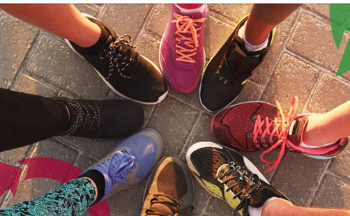 feet in a circle with sneakers on the feet